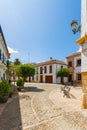 Small narrow street with white houses and abundant greenery in the old European city. Ronda, Andalusia, Spain Royalty Free Stock Photo