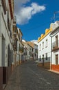 Small narrow street with white houses and blu sky in the old European city. Ronda, Andalusia, Spain Royalty Free Stock Photo