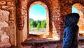 Small narrow windows on an old, ancient, cracked stone shabby brick wall of red brick in church. Architecture background Royalty Free Stock Photo