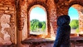 Small narrow windows on an old, ancient, cracked stone shabby brick wall of red brick in church. Architecture background Royalty Free Stock Photo