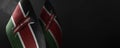 Small national flags of the Kenya on a dark background