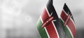 Small national flags of the Kenya on a light blurry background