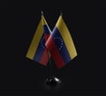Small national flags of the Venezuela on a black background