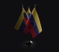 Small national flags of the Venezuela on a black background