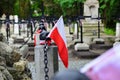 Small national pennon of Poland on the old cemetery. National Armed forces day concept.