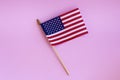 Small national state flag of United States of America on a pink background