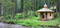 Small natural house, which is built of wood. The building is located in the forest