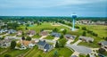 Small neighborhood aerial looking at culdesac and Auburn water tower behind houses