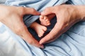 Small newborn baby legs in the hands of parents Royalty Free Stock Photo