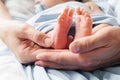 Small newborn baby legs in the hands of parents Royalty Free Stock Photo