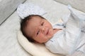 A small newborn boy 7 days in the hospital Looking at the camera. Hair dark skin dark