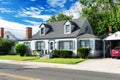 Small nice house with a well-groomed lawn. Blue sky on a sunny day