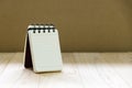 Small note book paper notepad stand on wood table for writing an information