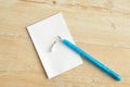 Small note pad with a blue pencil