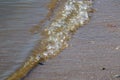 Small Ocean Wave Rolling on Sandy Beach Shore with Clear Water Royalty Free Stock Photo