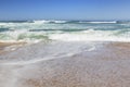 Small Ocean Waves Crashing On A Beach