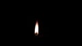 Small oil candle lit and burns bright in the dark spirituality, small lamp burning and jugglers behind it, a small icon-lamp in wr