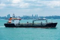 Small oil tanker ship sailing near port of Singapore.