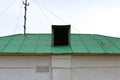 Small old attic on a green roof