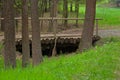 A small old bridge built of round wooden logs. Royalty Free Stock Photo