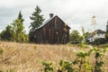 Small, old, brown barn in rural neighborhood Royalty Free Stock Photo