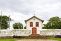 Small and old church and crucifix in colonial architecture Royalty Free Stock Photo