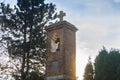 Small old church tower in the sunlight with sky in background Royalty Free Stock Photo