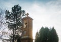 Small old church tower in the sunlight with sky in background Royalty Free Stock Photo