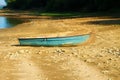 Small old fishing boat on a lake shore. Lake background. Royalty Free Stock Photo