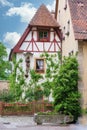 Small, old house with half-timbered, behind a garden fence Royalty Free Stock Photo