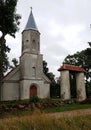 Small old Lutheran church in the Latvian village of Renda against the backdrop of cloudy sky in the summer of 2021