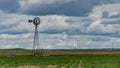 Small old wind turbine in a field against a cloudy sky in Tennessee, US Royalty Free Stock Photo