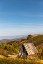 Small old wooden abandoned shepherds house on hill against mountain landscape. Carpathian Mountains, Paltinis, Romania Royalty Free Stock Photo