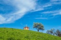 Small old wooden chapel on summer green grassy hill top Royalty Free Stock Photo