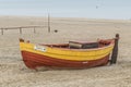 Old wooden clinket built fishing boat on a sandy beach Royalty Free Stock Photo