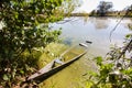 Small old wooden fishing boat punt on the bank of a lake, bright sunny day Royalty Free Stock Photo