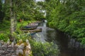 Small old wooden paddle boats moored in a row on narrow canal Royalty Free Stock Photo