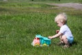 Small one year old boy child playing with toy truck car in the park Royalty Free Stock Photo