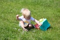 Small one year old boy child playing with toy truck car in the park Royalty Free Stock Photo