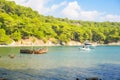 Small open boat for pleasure and fishing stands on water on sunny day against