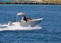 Small open fishing boat powered by a single outboard engine Royalty Free Stock Photo