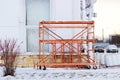 small orange building mobile work scaffolding near a large sports complex. Royalty Free Stock Photo