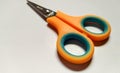 small orange hair scissors that are very multifunctional
