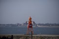 Small orange lighthouse on Esbjerg harbor in Denmark