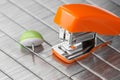 Small orange stapler on staples bed Royalty Free Stock Photo