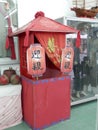 Small ornamental buddist shrine covered in red cloth