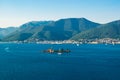 Small Our Lady of Mercy Island landscape. Porto Montenegro Marina at background, located near Tivat city at foot of Vrmac mountain Royalty Free Stock Photo