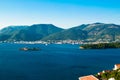 Small Our Lady of Mercy Island landscape. Porto Montenegro Marina at background, located near Tivat city at foot of Vrmac mountain Royalty Free Stock Photo