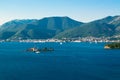 Small Our Lady of Mercy Island landscape. Porto Montenegro Marina at background, located near Tivat city at foot of Vrmac mountain Royalty Free Stock Photo
