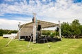 Small outdoor concert venue stage and lighting in a empty field Royalty Free Stock Photo